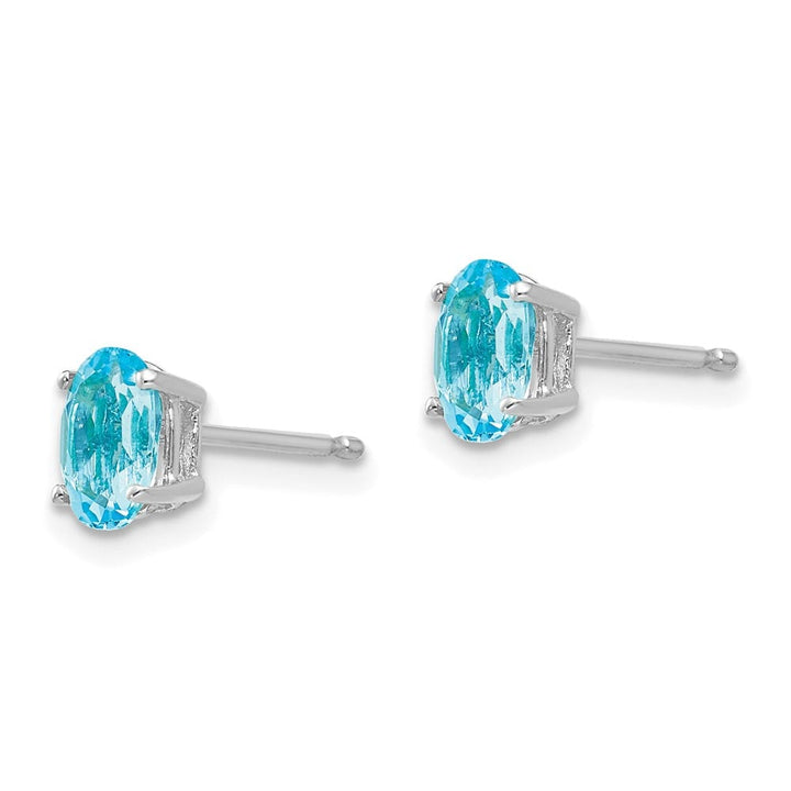14K White Gold 6x4mm Oval Blue Topaz Post Earrings, view 2 of 4