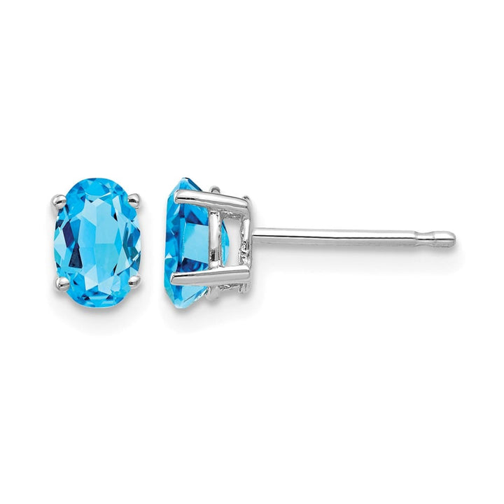 14K White Gold 6x4mm Oval Blue Topaz Post Earrings, view 1 of 4