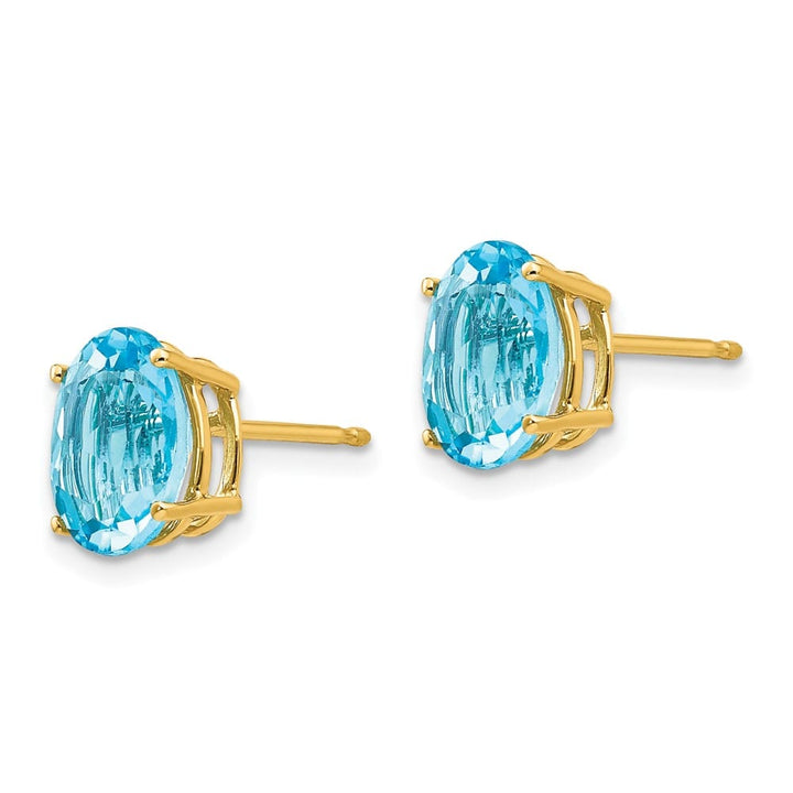 14K Yellow Gold 9x7mm Oval Blue Topaz Post Earrings, view 2 of 4