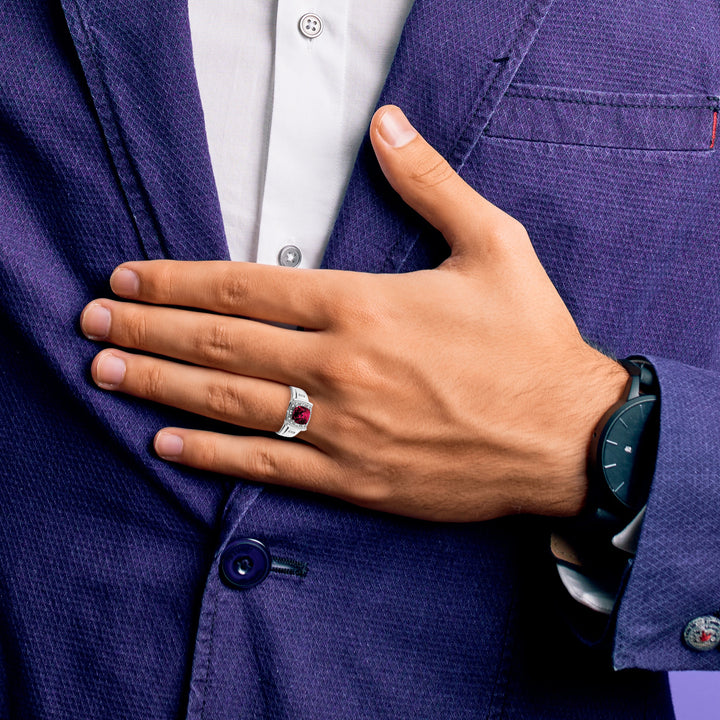 Man wearing 14k white gold cushion created ruby and diamond mens ring with purple suit.