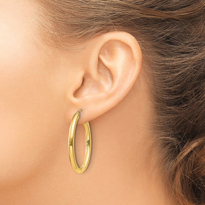 Lovely Rita's Earrings 14K Yellow Gold Classic Polished 28.2 mm Oval Tube Hoop Earrings